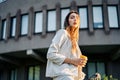 Young stylish woman in the street drinking morning coffee in sunshine light Royalty Free Stock Photo