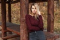 Young stylish woman in a trendy vintage sweater poses