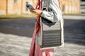 Woman charge phone from portable solar panel while walking outdoors