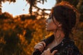 Young stylish woman wearing coat posing outdoors at sunset portrait Royalty Free Stock Photo
