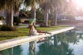 Young stylish woman wearing sunhat and dress enjoying summer tra