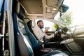 Young successful African American businessman talking on speakerphone through microphone with client, sitting in the Royalty Free Stock Photo