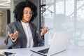 Young successful African-American businesswoman communicates via video call with clients, partners, conducts business Royalty Free Stock Photo