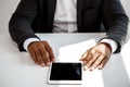 Young successful african businessman holding tablet, sitting at workplace. Royalty Free Stock Photo