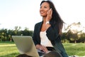 Young successful asaian business woman in black suit talking on Royalty Free Stock Photo