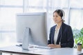 Young successful young asian businesswoman working with smartphone and laptop Royalty Free Stock Photo