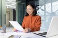 Young successful asian financier behind paper work inside office, businesswoman accountant reviewing contract documents Royalty Free Stock Photo