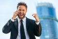 Young Successful Business Man Celebrating and Talking Cell Phone Royalty Free Stock Photo