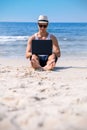 Young successful business man working with laptop on the beautiful tropical beach. Royalty Free Stock Photo