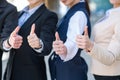 Young successful business women showing thumbs up. Close-up photography.