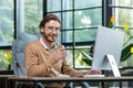 Young successful businessman man in modern office at work smiling and looking at camera, businessman holding glass of Royalty Free Stock Photo