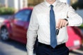 Young successful businessman offering a car key. Royalty Free Stock Photo