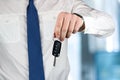 Young successful businessman offering a car key. Close-up of dri Royalty Free Stock Photo