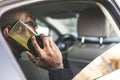 Young successful businessman talking on the phone sitting in the backseat of a expensive car. Negotiations and business Royalty Free Stock Photo