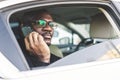 Young successful businessman talking on the phone sitting in the backseat of a expensive car. Negotiations and business Royalty Free Stock Photo