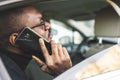 Young successful businessman talking on the phone sitting in the backseat of a expensive car. Negotiations and business Royalty Free Stock Photo