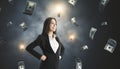 Young successful businesswoman with dollar bill money rain on wall background. Success, money and lottery winner concept Royalty Free Stock Photo