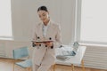 Young successful businesswoman working on business plan at office