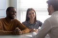 Young successful couple, diverse man and woman listening manager. Royalty Free Stock Photo