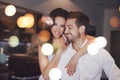 Young successful couple smiling, woman embrace man indoors, boke Royalty Free Stock Photo