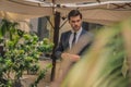 Young and successful. Handsome young man in full suit adjusting his jacket while standing outdoors Royalty Free Stock Photo