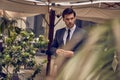 Young and successful. Handsome young man in full suit adjusting his jacket while standing outdoors Royalty Free Stock Photo