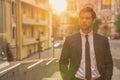 Young and successful. Handsome young man in full suit posing while standing outdoors