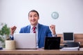 Young successful male employee working in the office Royalty Free Stock Photo