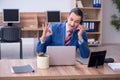 Young successful male employee working in the office Royalty Free Stock Photo