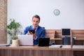 Young successful male employee working in the office Royalty Free Stock Photo