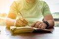 A young successful person taking notes in a personal journal