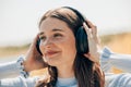 Young sunlit cute excited traveler tourist woman 20s wearing shirt summer casual clothes headphones listening to music