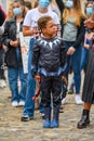A young Superhero at a Black Lives Matter protest with white protesters wearing PPE masks in the background