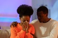 Young supportive african husband comforting crying wife, apologizing and asking for forgiveness Royalty Free Stock Photo