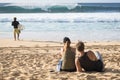 Banzai Pipeline, Oahu, Hawaii / USA - February 21 2018: Young surfer and a couple are watching big wave surfing Royalty Free Stock Photo