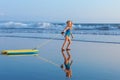 Young surfer girl with bodyboard walks along beach sea surf Royalty Free Stock Photo