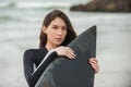 Young surfer girl and her black board.