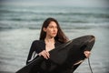 Young surfer girl and her black board.