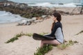 Young surfer girl overlooking beach.