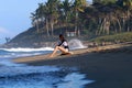 Young surfer girl sitting on the beach during sunset Royalty Free Stock Photo