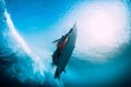 Young surfer girl with surfboard dive underwater with fun under big ocean wave. Royalty Free Stock Photo