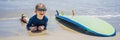 Young surfer, happy young boy at the beach with surfboard BANNER, LONG FORMAT Royalty Free Stock Photo