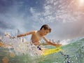 Young surfer, happy young boy in the ocean on surfboard Royalty Free Stock Photo