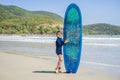 Young surfer, happy young boy at the beach with surfboard Royalty Free Stock Photo