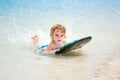 Young surfer, happy young boy in the ocean on surfboard. Royalty Free Stock Photo