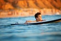Young surfer, happy young boy in the ocean on surfboard Royalty Free Stock Photo