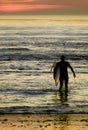 Young surfer heading back out for his last wave of the day.