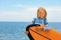 Young surfer learn to ride on surfboard on sea waves Royalty Free Stock Photo