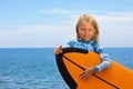 Young surfer learn to ride on surfboard on sea waves Royalty Free Stock Photo