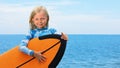 Young surfer learn to ride on surfboard on sea waves Royalty Free Stock Photo